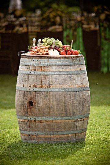Wine barrel bar with food display on grass